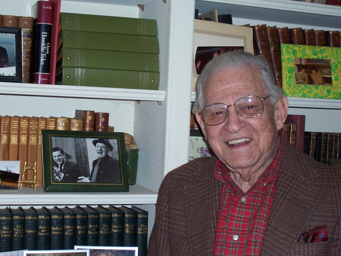 Len Goorian posed in his home with a photo of him interviewing Jimmy Durante on WKRC-TV in 2009.